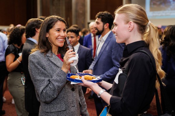 Attendees talking, eating, and drinking